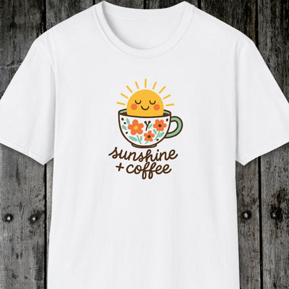 Sunshine And Coffee T-Shirt featuring a smiling sun and floral coffee cup graphic. Soft, lightweight cotton, unisex fit, perfect for adventures and casual wear.
