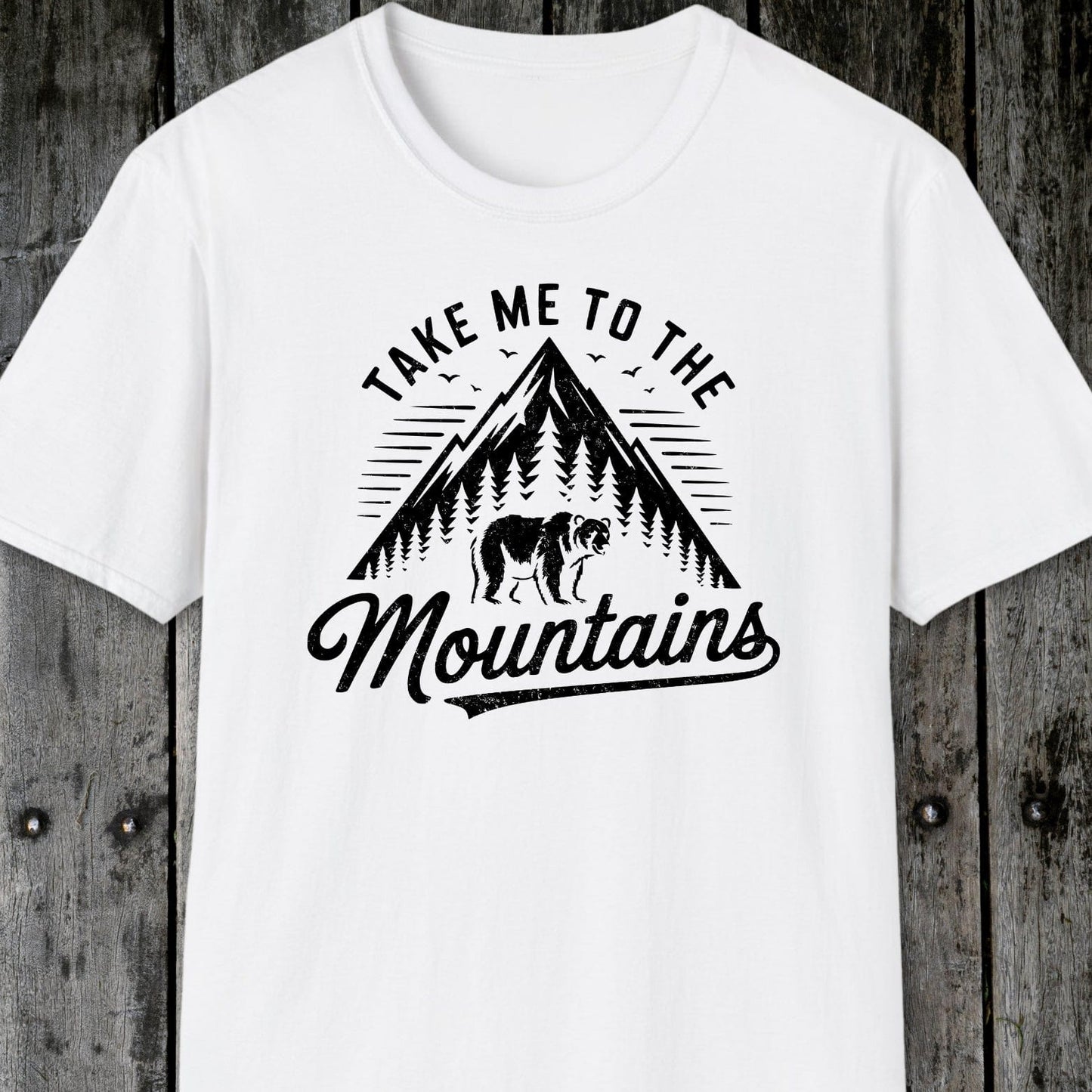Take Me To The Mountains T-Shirt with a mountain and bear graphic, designed for comfort and adventure, featuring durable prints and a unisex fit.