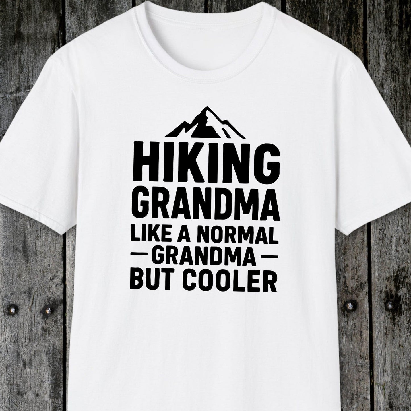 White T-shirt featuring a mountain graphic and Hiking Grandma text, crafted from soft cotton for comfort, designed for outdoor enthusiasts.