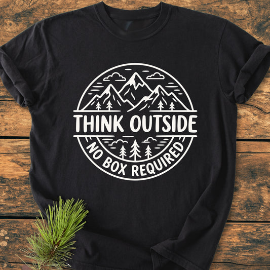 The Think Outside - Vintage Wash Tee features a white graphic of mountains and trees with the slogan “THINK OUTSIDE” on a black T-shirt, showcasing its relaxed, durable design.