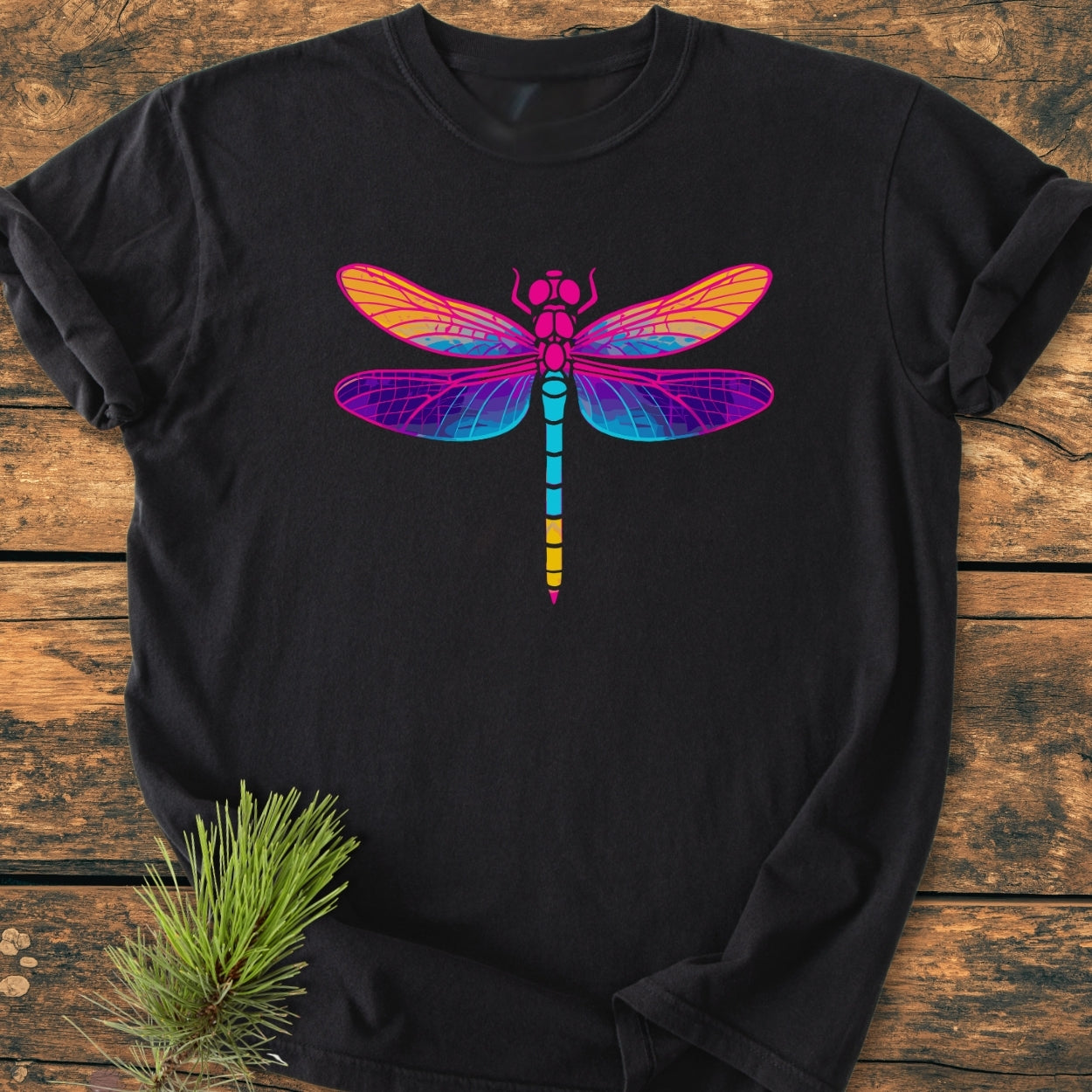 Psychedelic Dragonfly - Vintage Wash Tee: Black T-shirt with a vibrant dragonfly graphic in gradient hues, laid on wood. Features garment-dyed, soft-washed fabric, ensuring comfort and durability.