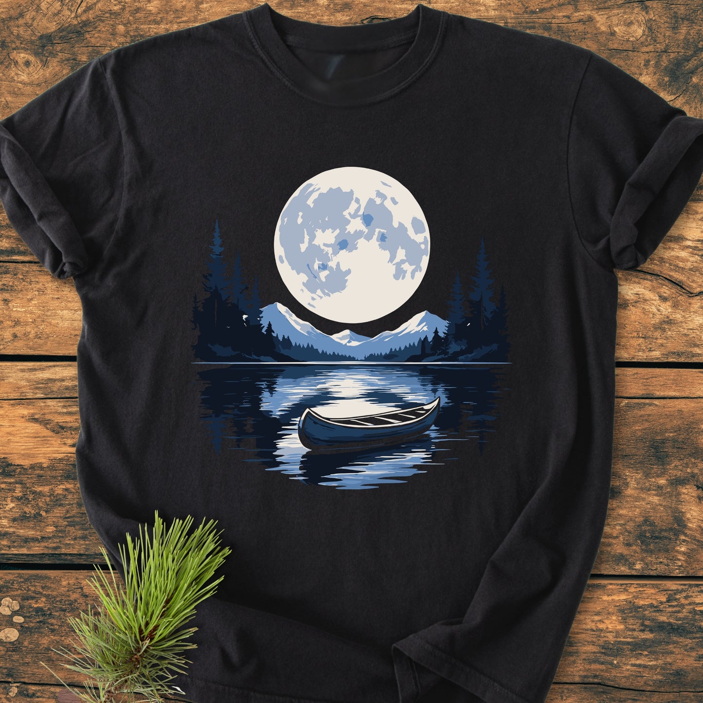 Moonlit Canoe - Vintage Wash Tee features a stylized lake scene with a moonlit canoe, printed on a black T-shirt. Crafted from soft, garment-dyed cotton for comfort and durability.