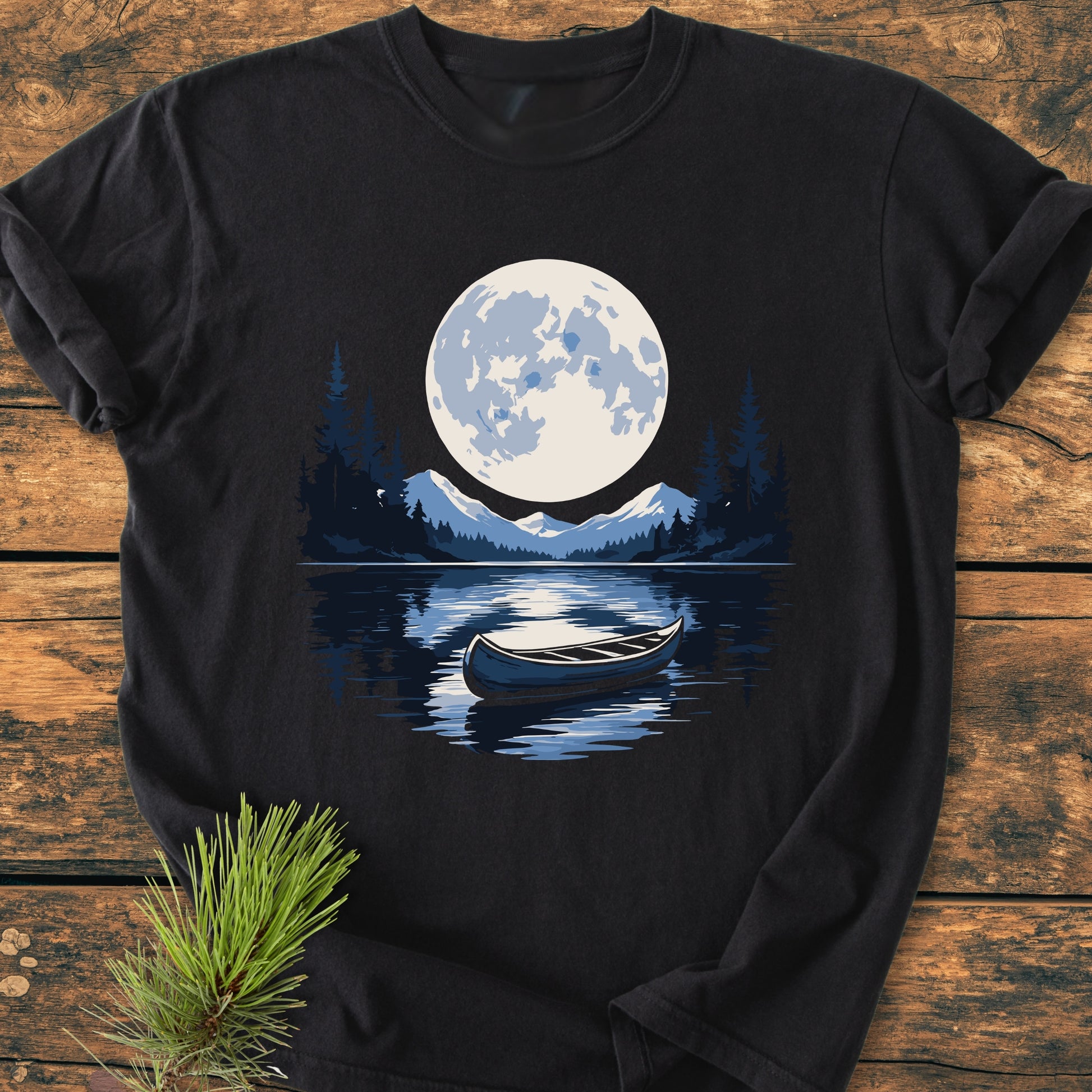 Moonlit Canoe - Vintage Wash Tee features a stylized lake scene with a moonlit canoe, printed on a black T-shirt. Crafted from soft, garment-dyed cotton for comfort and durability.