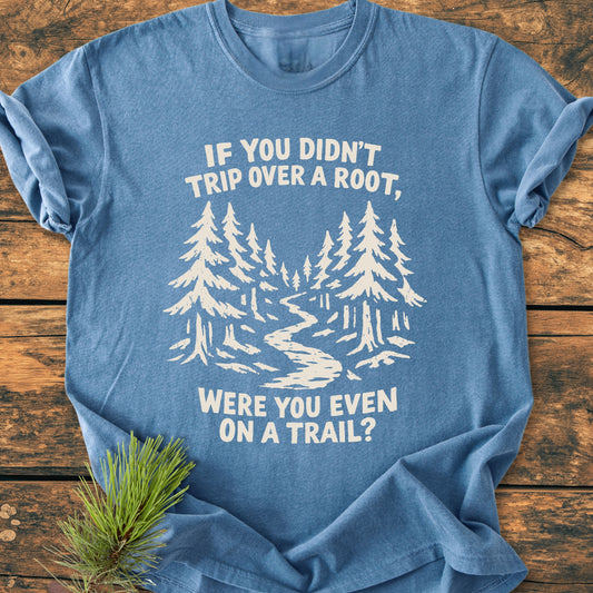 Were You Even On A Trail? - Vintage Wash Tee features a stylized forest scene with pine trees and trail, printed in off-white on a heather-blue T-shirt, complemented by a sprig of pine needles.