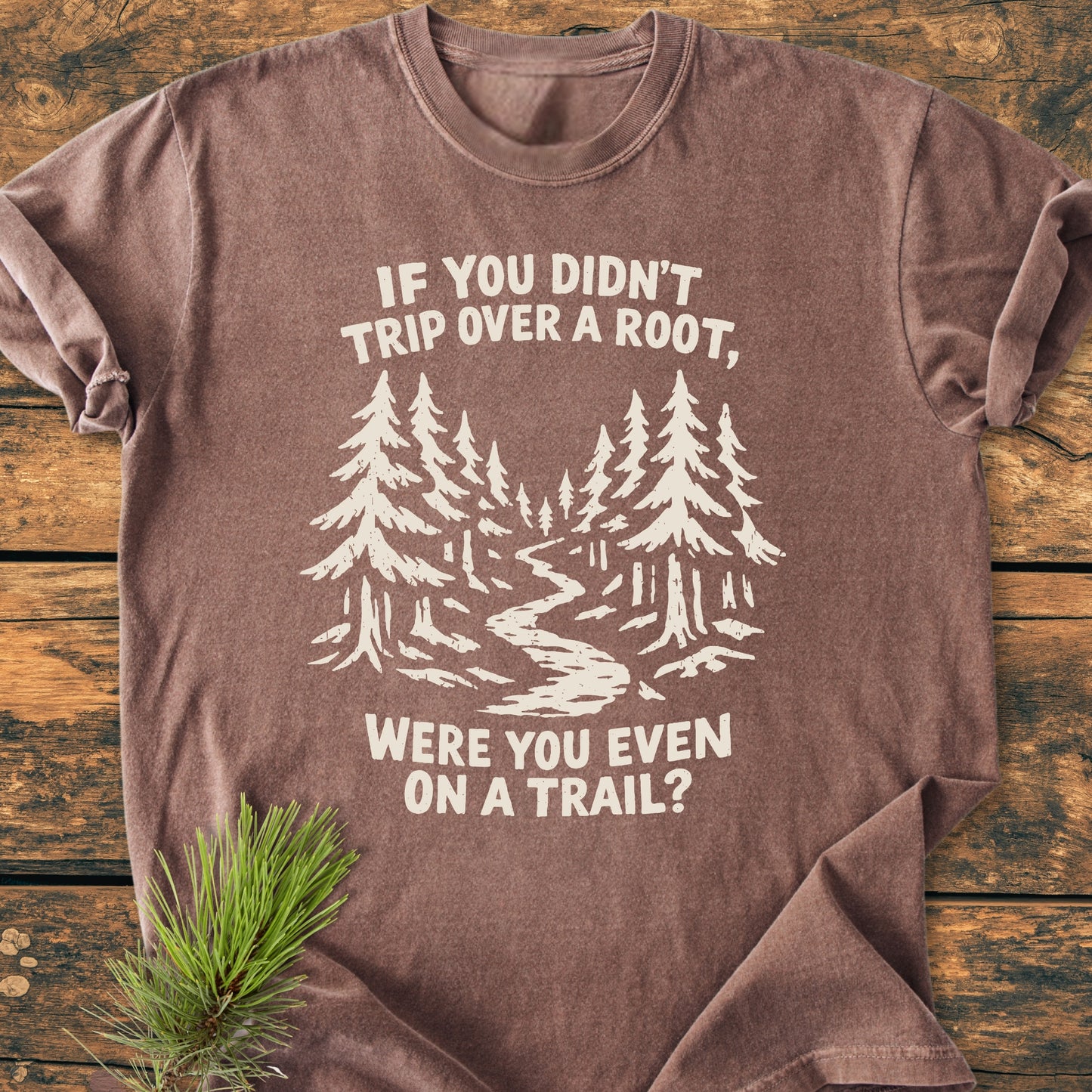 Were You Even On A Trail? - Vintage Wash Tee features a stylized forest scene and playful caption, printed on a laid-out brown T-shirt, highlighting its relaxed fit and soft, garment-dyed cotton fabric.