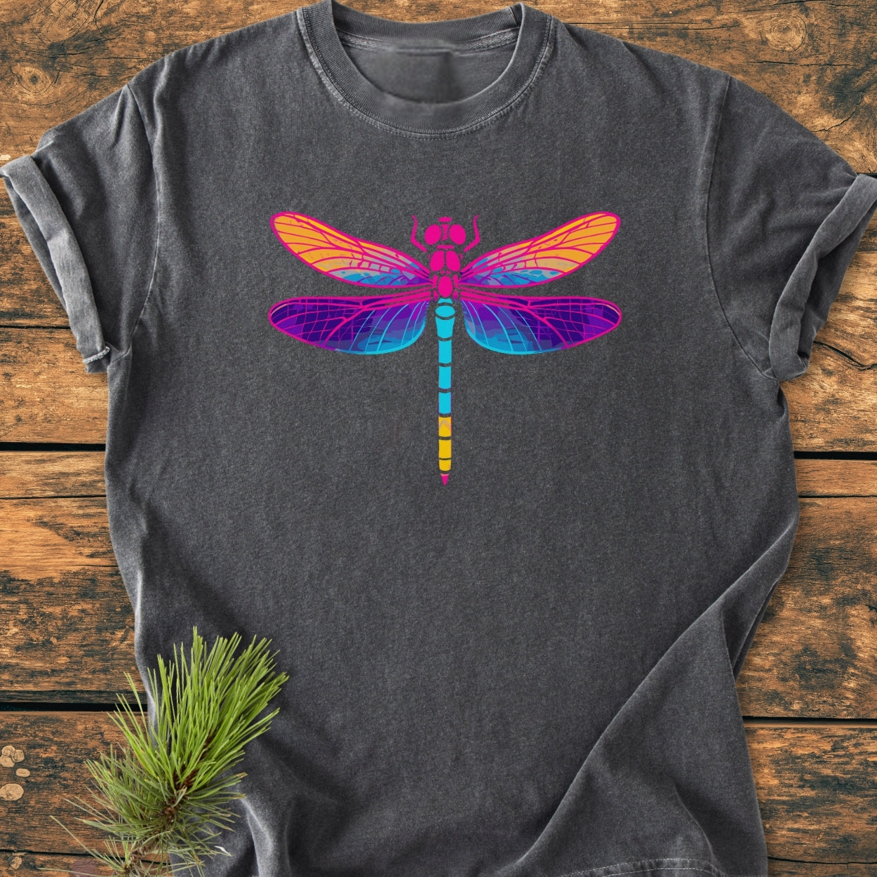 Psychedelic Dragonfly - Vintage Wash Tee: Charcoal-gray short-sleeve t-shirt with a vibrant dragonfly graphic, laid on rustic wood. Features soft, garment-dyed cotton and relaxed fit, showcasing durability and comfort.