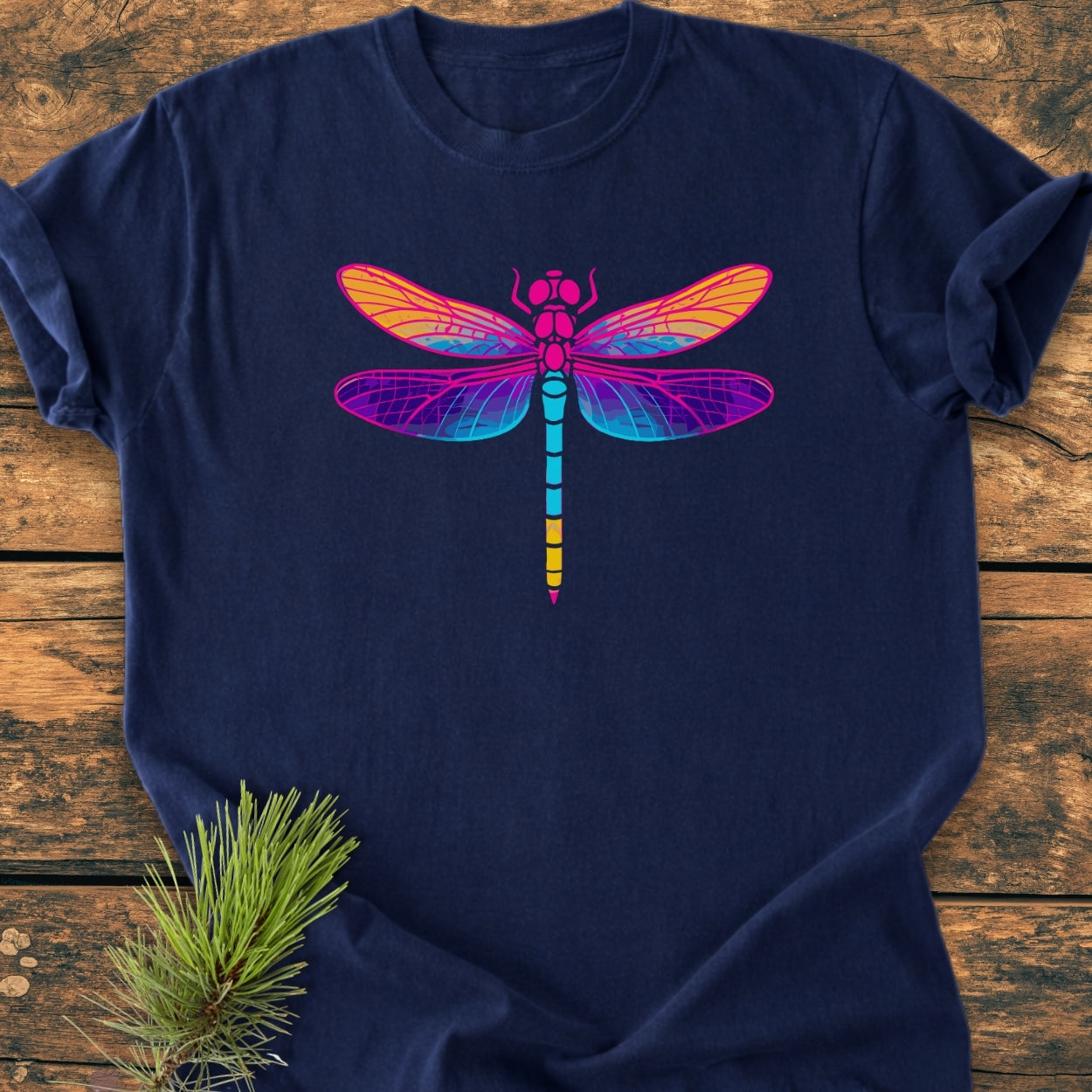 Psychedelic Dragonfly - Vintage Wash Tee on wooden surface, featuring a vibrant dragonfly graphic. The soft, navy-blue, garment-dyed fabric and relaxed fit offer comfort and style, enhanced by durable double-needle stitching.