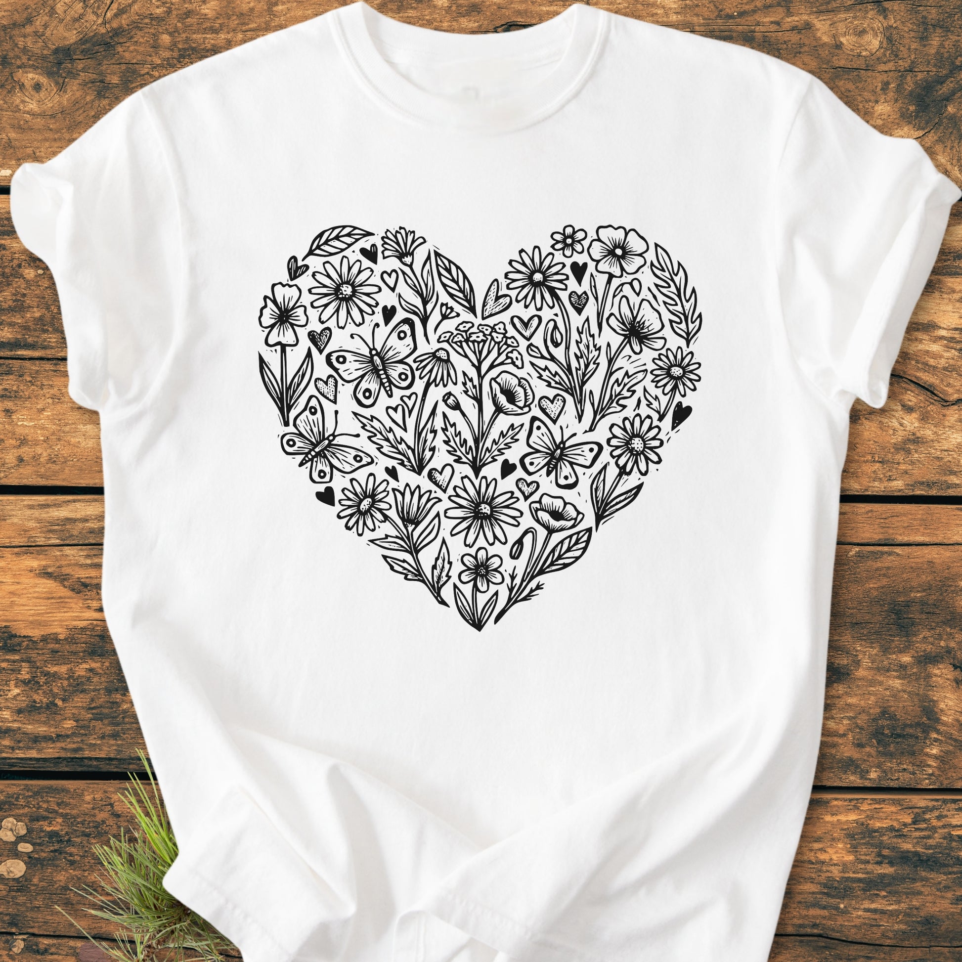 Wildflower Heart Butterfly Soul - Vintage Heavyweight Tee features a hand-drawn floral heart motif with butterflies on a white, laid-flat tee, showcasing its relaxed fit and durable, soft-washed fabric.