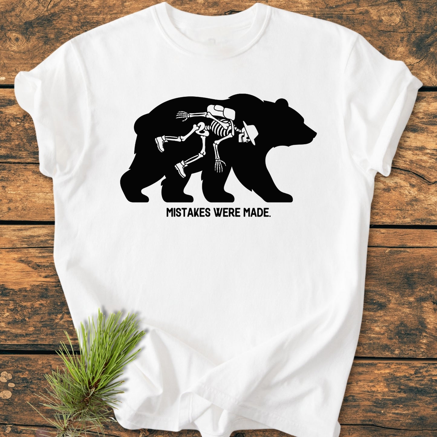 Mistakes Were Made - Vintage Wash Tee featuring a black bear silhouette with a cartoon hiker skeleton inside, captioned humorously. Relaxed fit, durable stitching, 100% ring-spun cotton, ideal for daily wear.