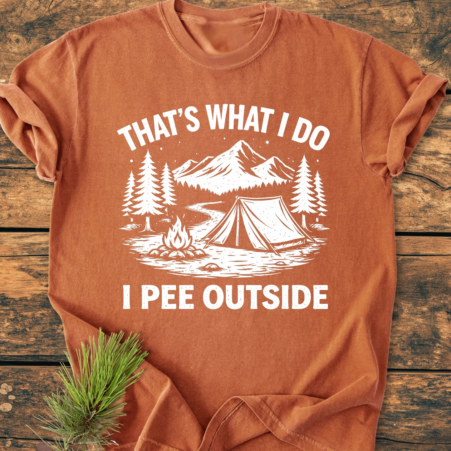 I Pee Outside - Vintage Wash Tee featuring a stylized camping scene, including mountains, pine trees, and a campfire, printed on a rust-orange Comfort Colors garment-dyed, 100% ring-spun cotton T-shirt.