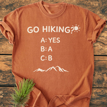 Go Hiking? - Vintage Wash Tee featuring playful white text and mountain silhouette on rust-orange fabric, offering a soft-washed, relaxed fit for everyday comfort.