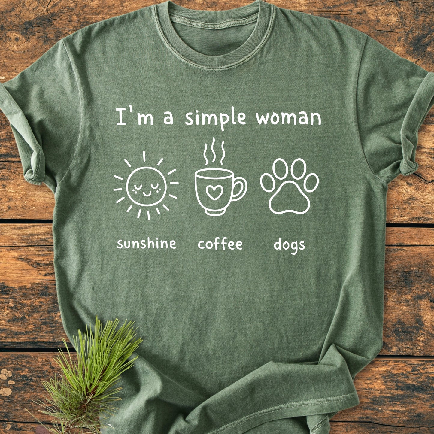 I'm A Simple Woman. Sunshine Coffee Dogs - Vintage Wash Tee features a relaxed green shirt with icons of a sun, coffee mug, and dog paw, highlighting life's simple pleasures.