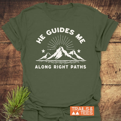 He Guides Me T-Shirt featuring a mountain scene with sun-rays and stars, crafted from soft ring-spun cotton. Durable print, taped shoulders, and no side seams for lasting comfort and shape.