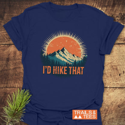 I'd Hike That T-Shirt features a sun and mountains graphic with 'I'D HIKE THAT' slogan. The unisex, soft cotton tee is perfect for adventures, featuring the Trails & Tees logo.