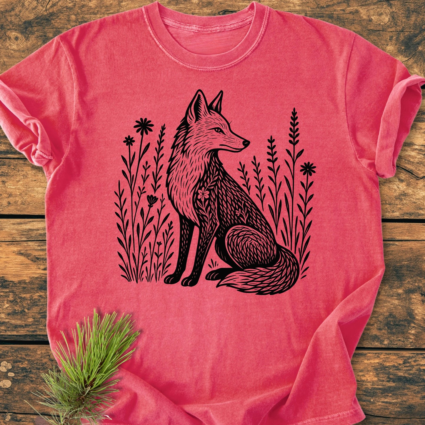 T-shirt titled 225 Wildflower Fox DARK, featuring a black stylized fox among wildflowers, laid on wood. Made from 100% ring-spun cotton with a relaxed fit and durable double-needle stitching.