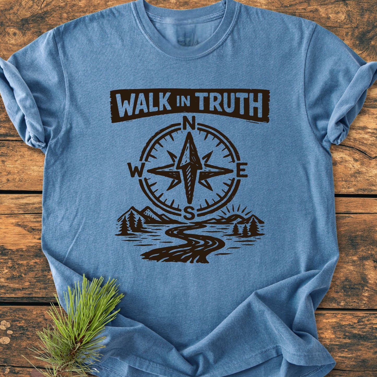 Heather-blue Walk In Truth 3 John 1,4 - Vintage Wash Tee featuring compass, path, mountains, and sun design, laid flat with pine sprig. Relaxed fit, durable Comfort Colors fabric, enhancing daily wear.