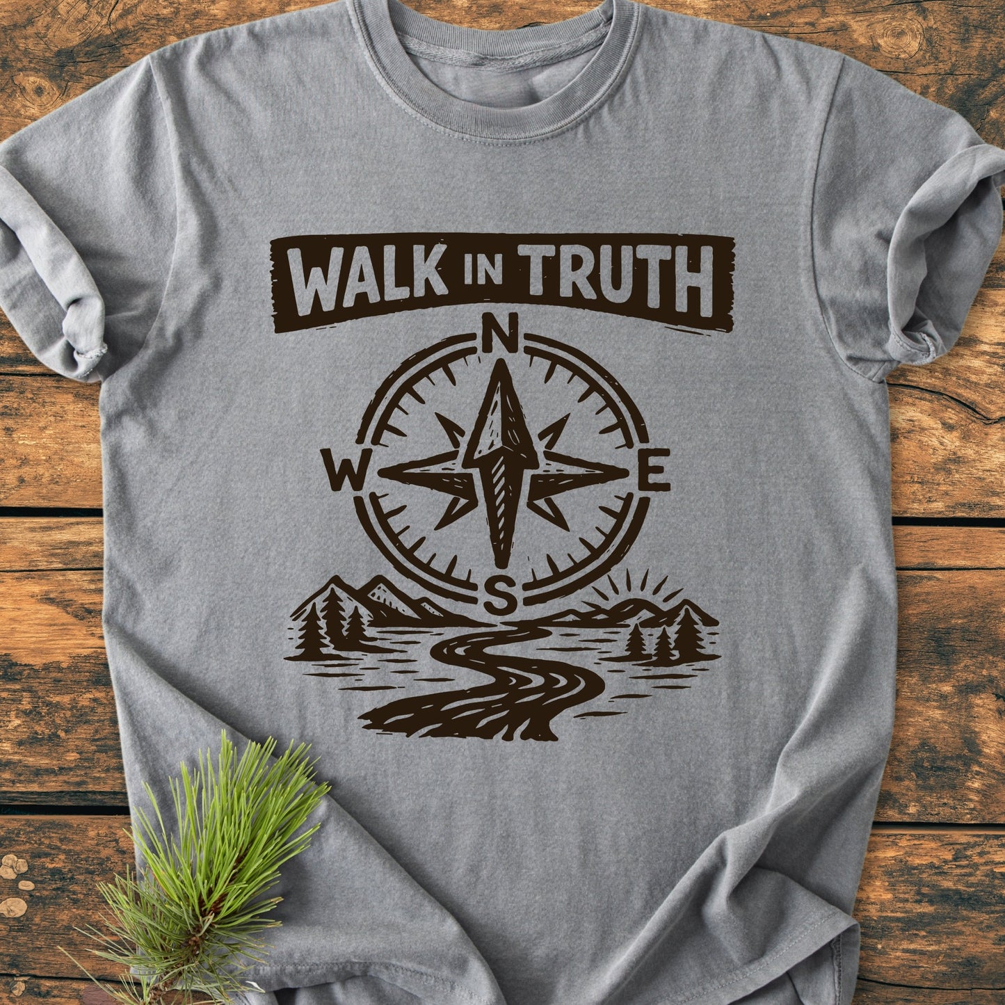 Walk In Truth 3 John 1,4 - Vintage Wash Tee features a woodcut-style graphic with WALK in TRUTH, compass rose, and scenic landscape on a heather-gray T-shirt, laid flat with pine sprig styling.